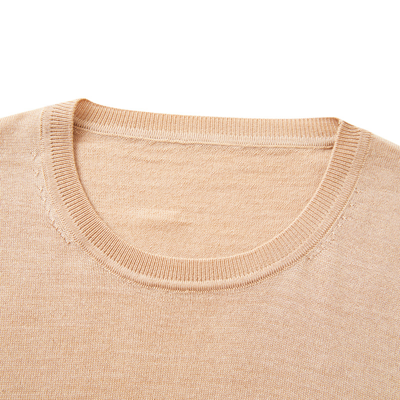 Close-up of fine gauge crew neck sweater collar showing ribbed neckline construction for premium knitwear